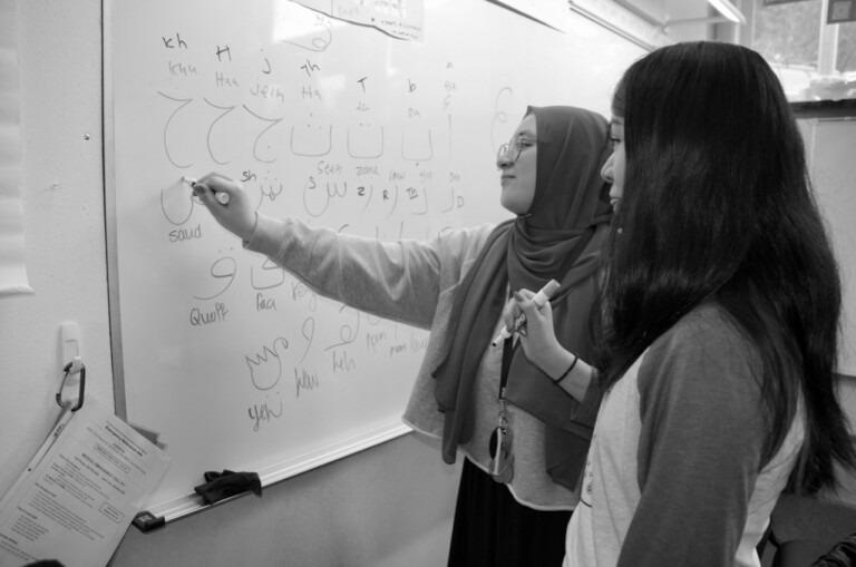 students writing on a whiteboard