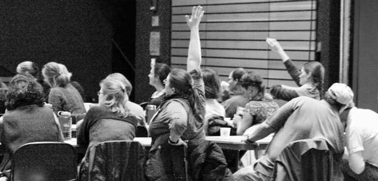 hands raised at teacher workshop